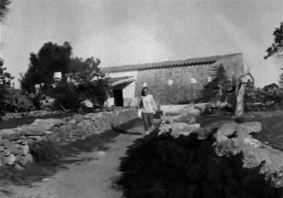 munford-ibiza-house-1-copy woman walking in fornt of a traditional ibicenco houese